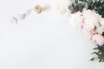 Feminine wedding or birthday table composition with floral bouquet. White and pink peonies flowers,...