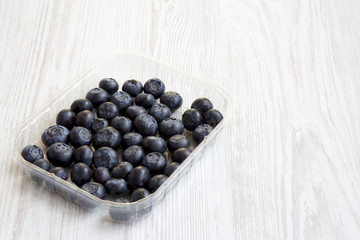 Blueberries in a plastic box, side view. Organic superfood. Copy space.