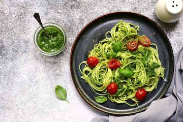 Spaghetti pasta with pesto sauce and cherry tomatoes.Top view.
