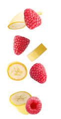Falling banana and raspberry fruits isolated on white background