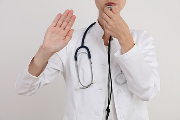 Doctor showing stop sign. Prevention, unhealthy lifestyle concept
