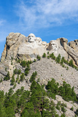 Fototapeta na wymiar Mount Rushmore national memorial, USA. Sunny day, blue sky. Vertical layout.