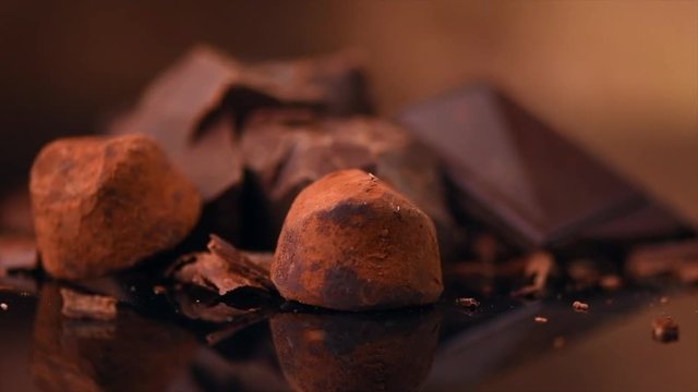 Chocolate. Assorted chocolate sweets and candies rotated over dark background. Confectionery concept. Rotation. 4K UHD video 3840X2160
