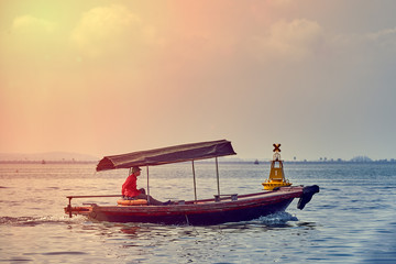 Naklejka na ściany i meble Fishing boat in Ha long Bay, Panoramic view of sunset in Halong Bay, Vietnam, Southeast Asia,UNESCO World Heritage Site