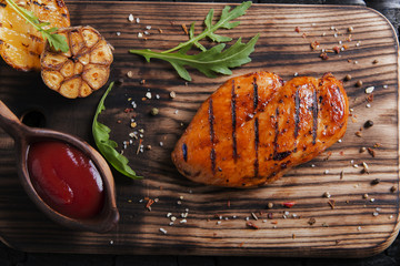 Grilled chicken fillet with sauce on charcoal