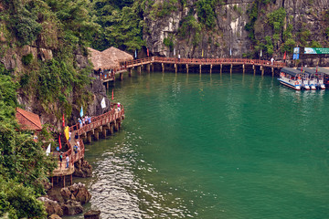 Ha Long Bay , Vietnam-29 November 2014:  Hang Sung Sot cave harbour and tourists who visited the Hang Sung Sot  cave,UNESCO World Heritage Site