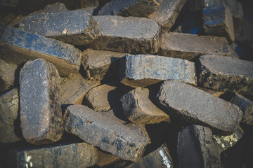Heap of peat briquettes, alternative fuels, raw material, matte effect and vignetting