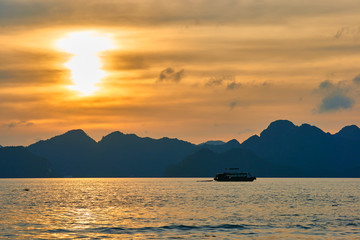 Naklejka na ściany i meble Tourist Junks in Halong Bay,Panoramic view of sunset in Halong Bay, Vietnam, Southeast Asia,UNESCO World Heritage Site