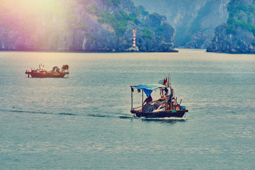 Fishing boat in Ha long Bay, Panoramic view of sunset in Halong Bay, Vietnam, Southeast Asia,UNESCO...