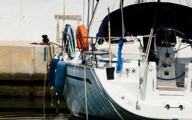 closeup on elements of yachts and motor boats anchored in the harbor, hot day at harbor