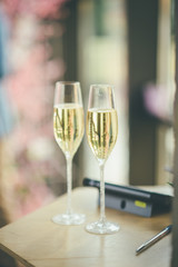 two blurred glasses of champagne for newlyweds