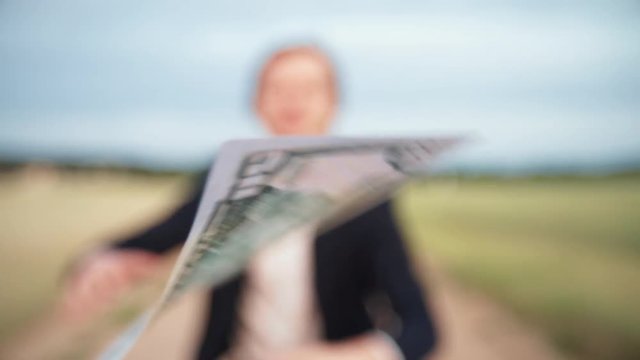 A man works after a dollar that flies driven by the wind. concept of the pursuit of profit and income