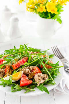 Salad with tuna. Vegetable salad with boiled egg, tuna and arugula. Fish salad