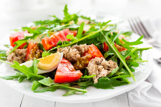 Salad with tuna. Vegetable salad with boiled egg, tuna and arugula. Fish salad