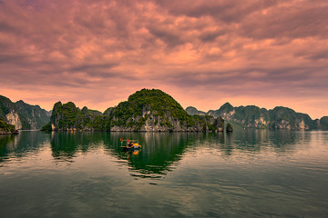 Fototapeta premium Halong bay boats, Vietnam Panoramic view of sunset in Halong Bay, Vietnam, Southeast Asia,UNESCO World Heritage Site
