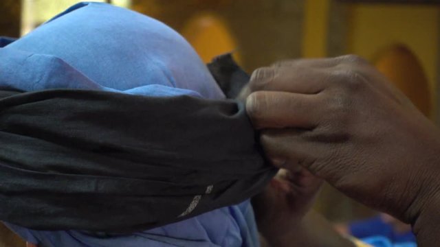 Putting on traditional Moroccan turban, close up