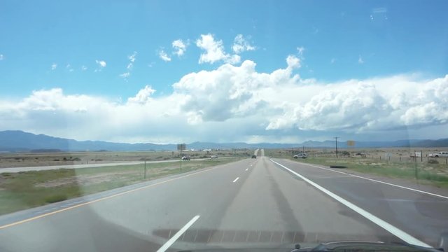 Landscape view while driving on highway, POV