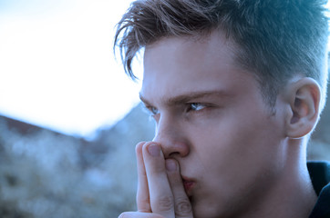 Mysterious teenager, having problems sadness, depression, holding finger over mouth 