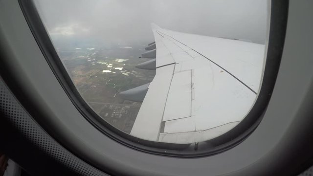 POV, takeoff view from window seat on a cloudy day
