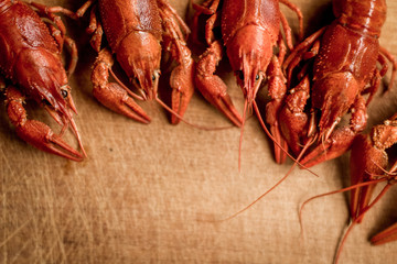 boiled crayfish food and drinks concept on wooden cutting board desk with empty space for copy or text