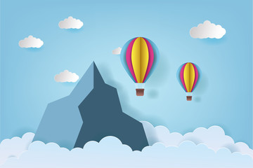 Origami made colorful hot air balloon flying over the mountain with cloud.Paper art style. Landscape vector illustration. Mountain background illustration.
