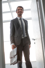 retro style.smiling businessman opening the door to his office