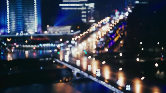 Cars riding across the river near the Arbat in Moscow, Russia. Summer night. Big city life concept. Locked down real time medium shot blurred