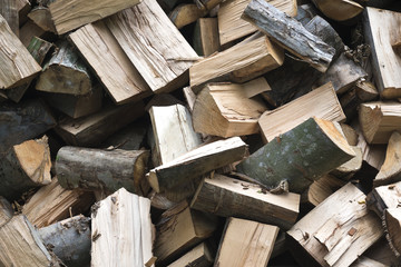 pile of chopped logs ready to be used as firewood texture background