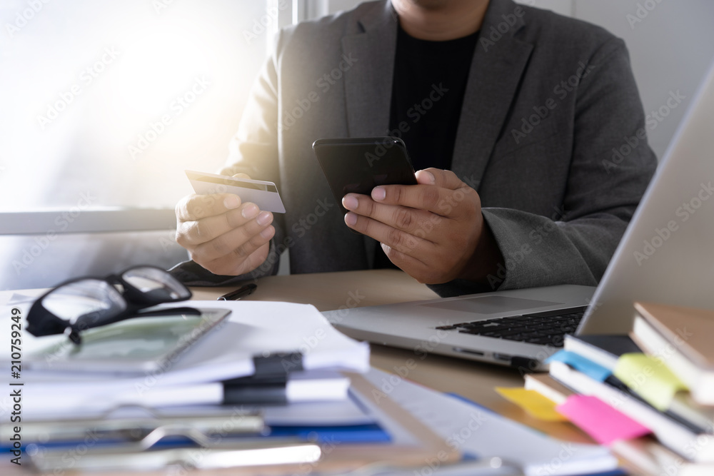 Poster businessman using phone smart phone and notebook computer