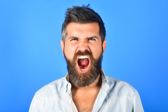 Angry man. Anger. Aggressive bearded man screaming. Man with long beard and mustache with angry face expression. Feeling and emotions. Close Up. Emotions. Feelings. Facial expressions concept.