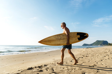 Naklejka na ściany i meble Surfer at a nice beach