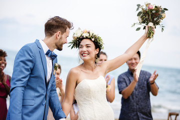 Bride throwing flower bouquet to guests