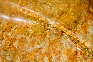 Riverbed of oranged cloured limestone background 2