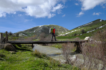 Hiker Crossing Bridge Over Creek In Nebrodi Park, Sicily