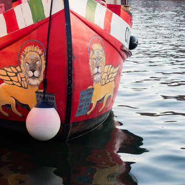 Italian fishing boat with the lion of St. Mark painted on the sides of the wooden keel.
