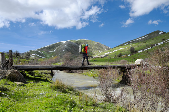 Hiker Crossing Bridge Over Creek In Nebrodi Park, Sicily