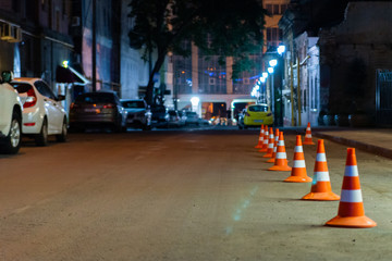 Traffic warning cone in row on street to separate place for parking area