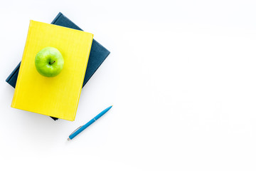Educational literature. School textbook, book, tutorial and apple on white background top view copy...