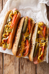 Delicious Chicago style hot dog with mustard, vegetables and relish close-up. vertical top view