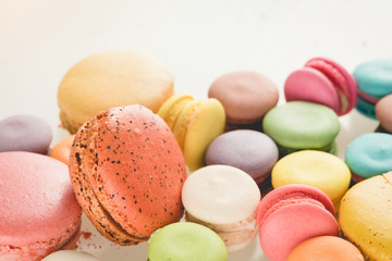 Colorful french macarons on white background.
