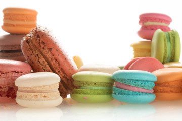 Colorful french macarons on white background.