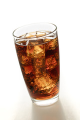 Cola in glass with ice on white background