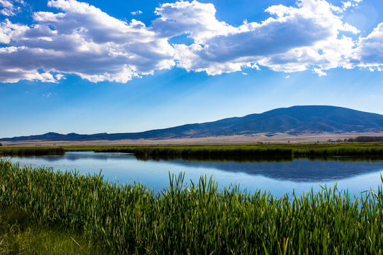 View of the great marsh at Monte Vista National Wildlife Refuge in southern Colorado, with the San Juan Mountains reflected in the water