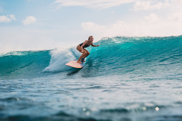 Surfer girl on surfboard. Surfer and wave - obrazy, fototapety, plakaty
