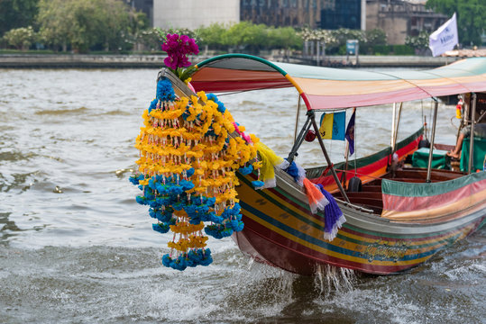 Traditional Thai boat decorated with flower garland