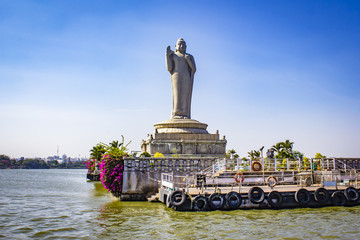 Sailing by the Giant Buddha Statue with Bright Pink Bougainvillea Plants in the Middle of Hussain Sagar Lake in Hyderabad, India