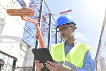 Construction supervisor inspecting building site