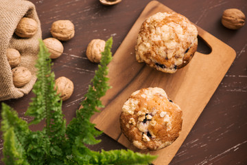 Tasty homemade walnut muffins on table. Sweet pastries