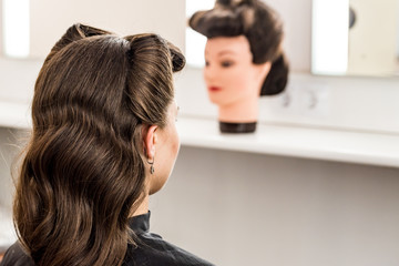 Fototapeta premium Back view woman at hairdresser's