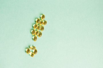 Yellow pills laid out in the form of an exclamation mark on a green background